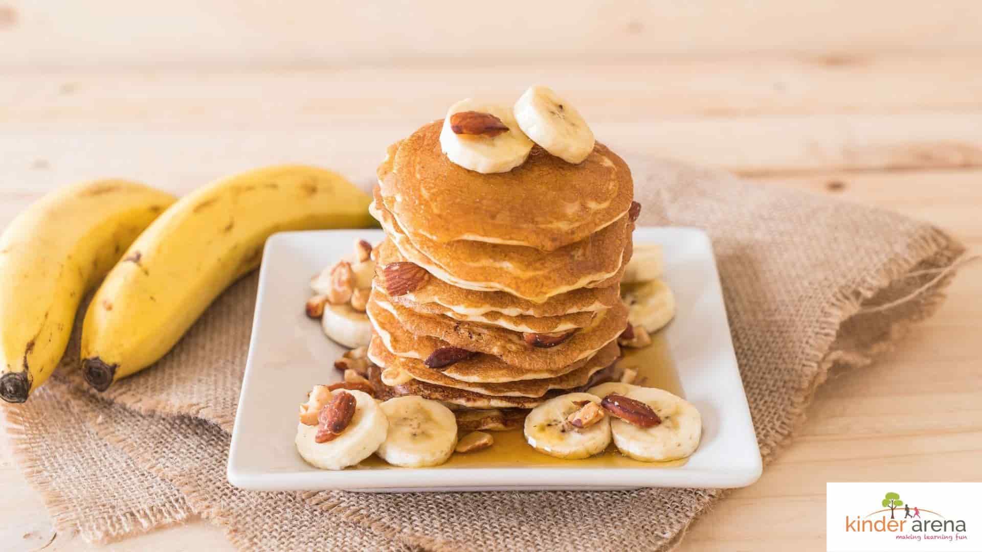 Healthy lunchbox idea for children, mini pancakes with yogurt and banana