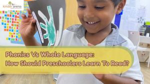 A preschooler in Kinder Arena readings through books