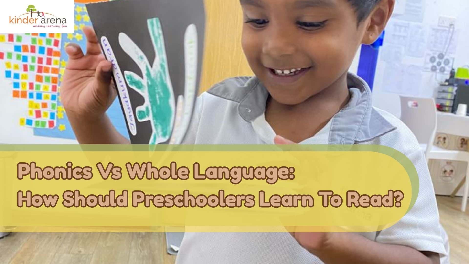 A preschooler in Kinder Arena readings through books